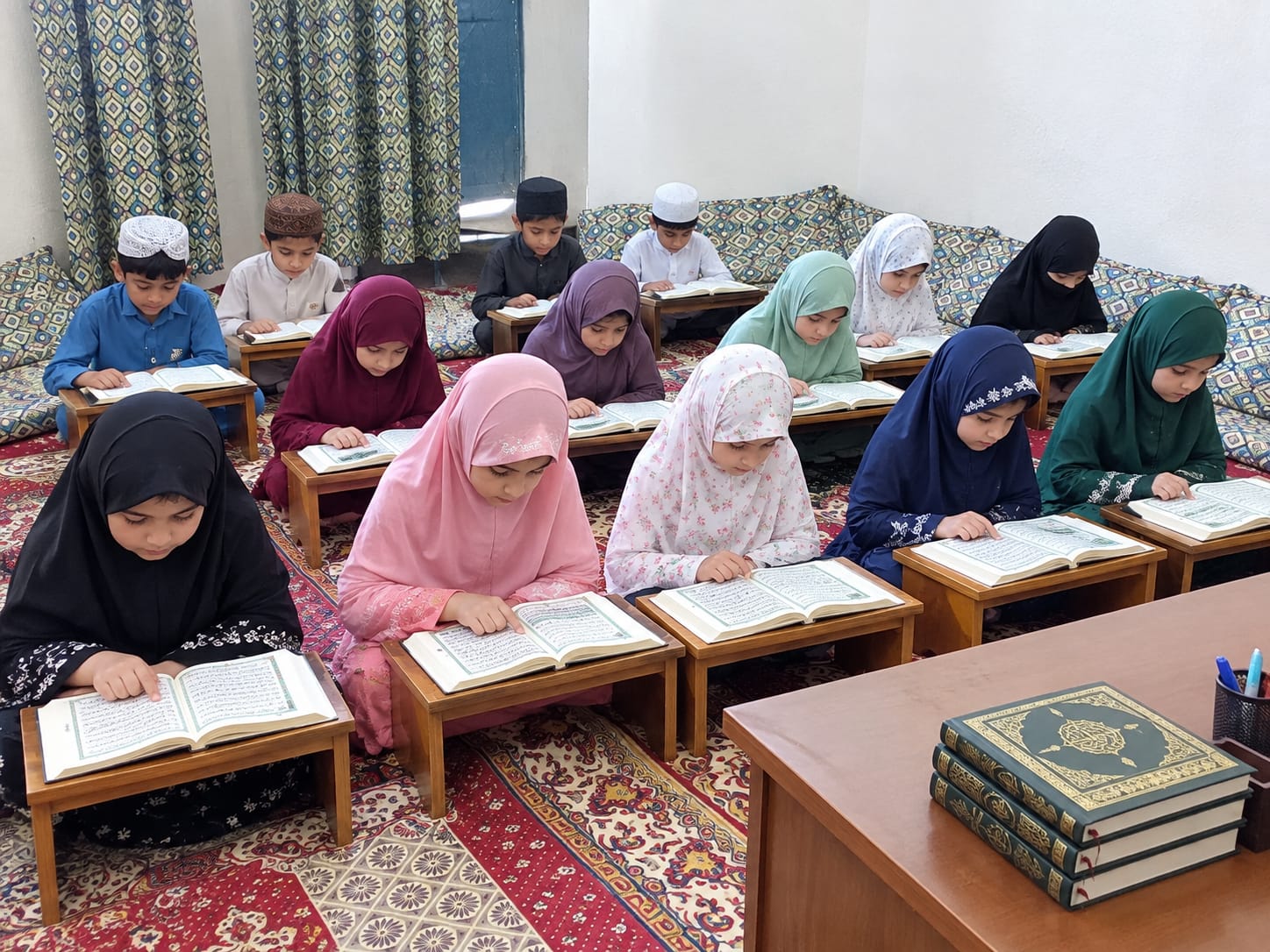 Children reading the Quran together in a classroom